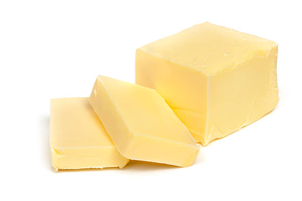 Stick of butter, cut, isolated on white.