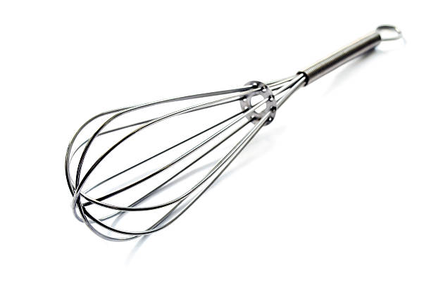 Manual metal egg whisk isolated over white background