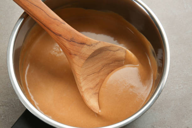 Delicious turkey gravy in saucepan on table